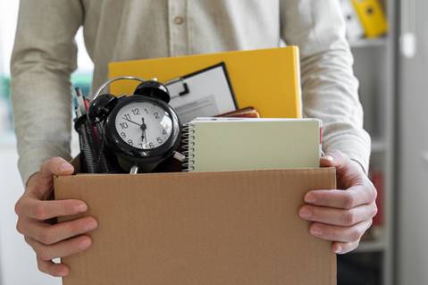 Man holding office belongings - Wrongful Termination